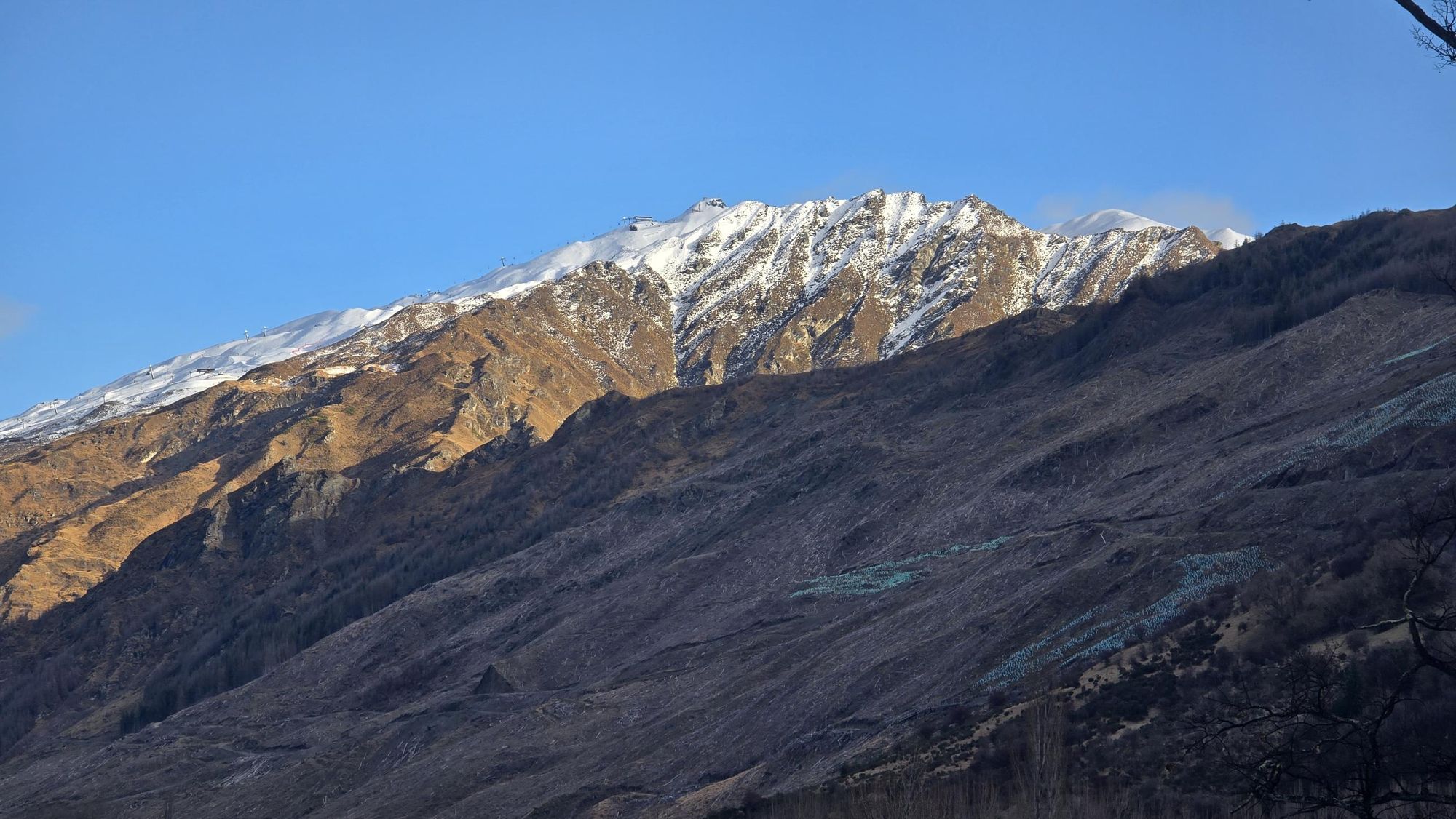 A snow-covered mountain ridge in late afternoon light